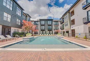 Courtyard pool with lounge chairs and landscaping